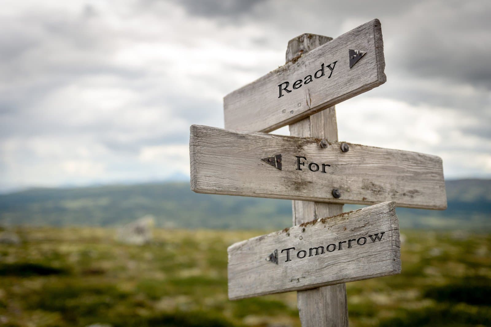 A weathered wooden signpost reading Ready For Tomorrow